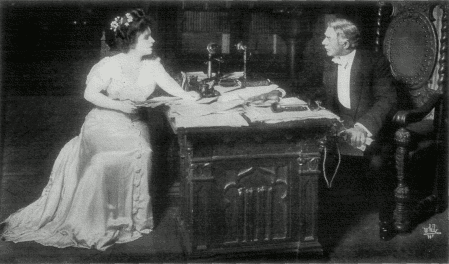 [Photo, from the play,
of Shirley discussing her book with Mr. Ryder]