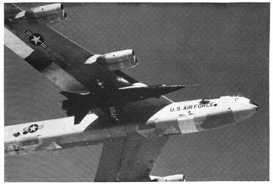 A U.&nbsp;S. Air Force plane in the air with a small plane attached under its wing
